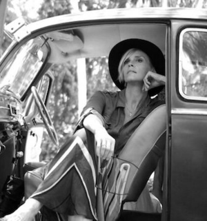Elizabeth Rosselle, Co-Founder, Writer and Web Designer at Three Word Agency, seated in a vintage car, gazing into the distance.